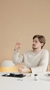 man holding syringe with insulin